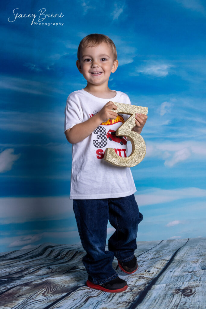 Birthday Third in studio holding prop. Stacey Brent Photography, Central Newfoundland.