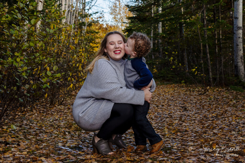 Family Session of son kissing mom during the Fall. Stacey Brent Photography, Central Newfoundland.