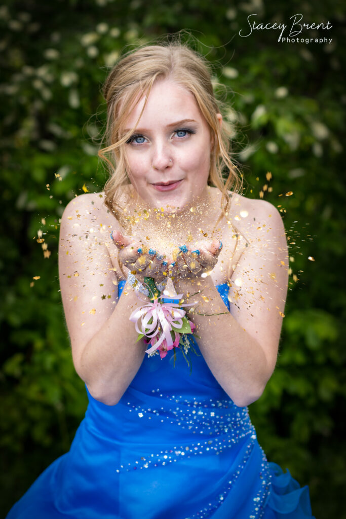 Senior Graduate blowing glitter. Stacey Brent Photography, Central Newfoundland.