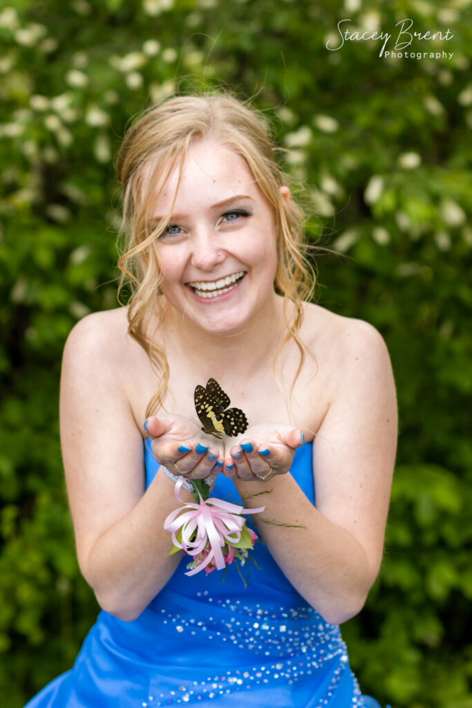 Senior Graduate with butterfly. Stacey Brent Photography, Central Newfoundland.