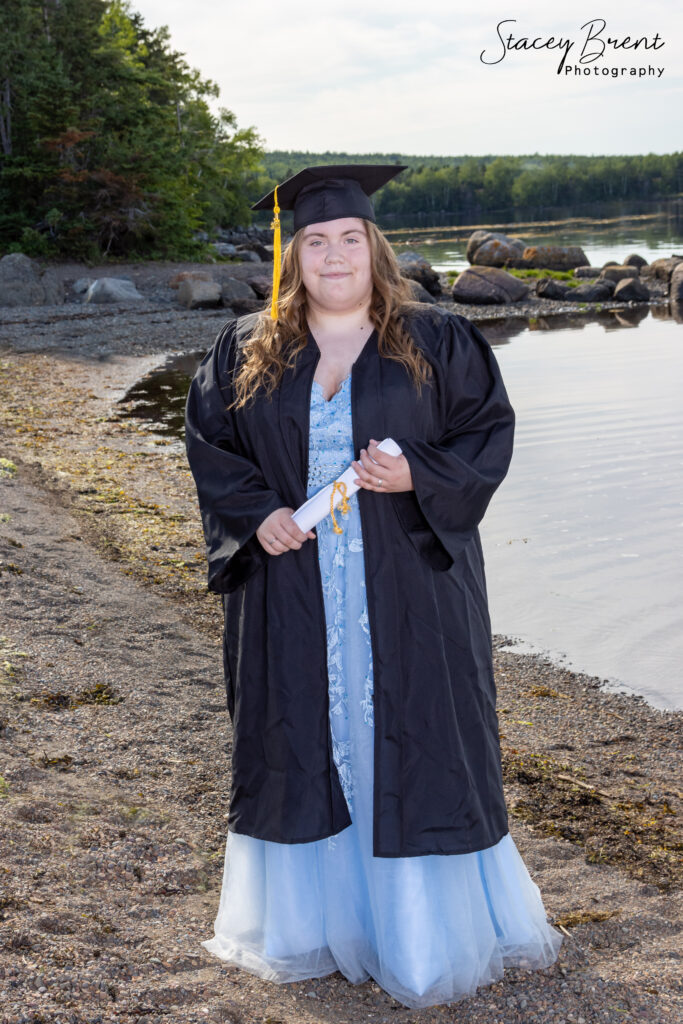 Senior Graduate with diploma on the beach. Stacey Brent Photography, Central Newfoundland.