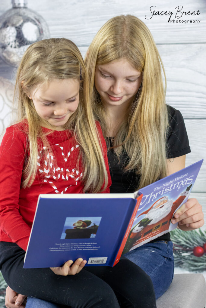 Sisters Reading a Christmas Book in Studio. Stacey Brent Photography, Central Newfoundland.