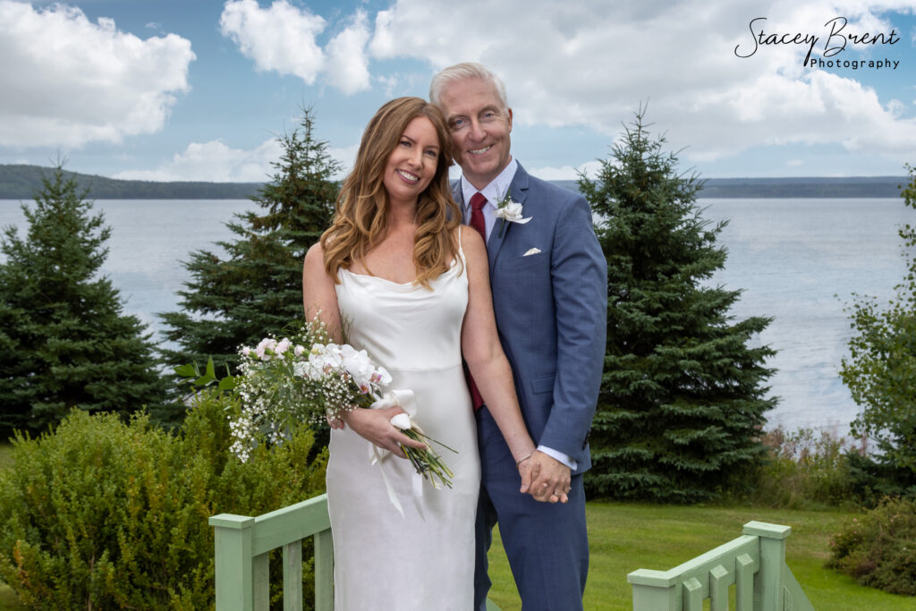 Wedding of bride and groom holding hands. Stacey Brent Photography, Central Newfoundland.