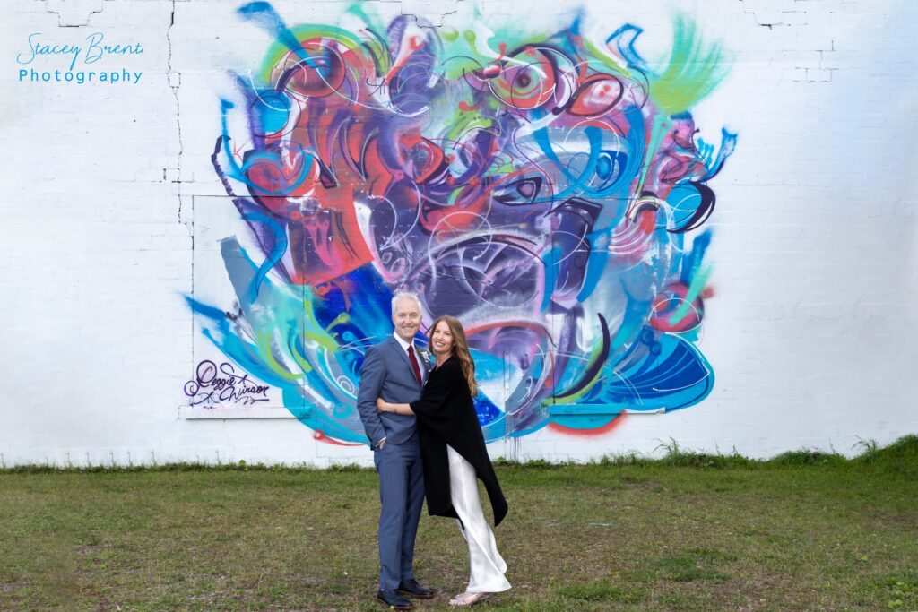 Wedding of bride and groom with Botwood Mural. Stacey Brent Photography, Central Newfoundland.